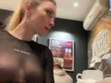 Flashing her big boobs in transparent top in public cafe.